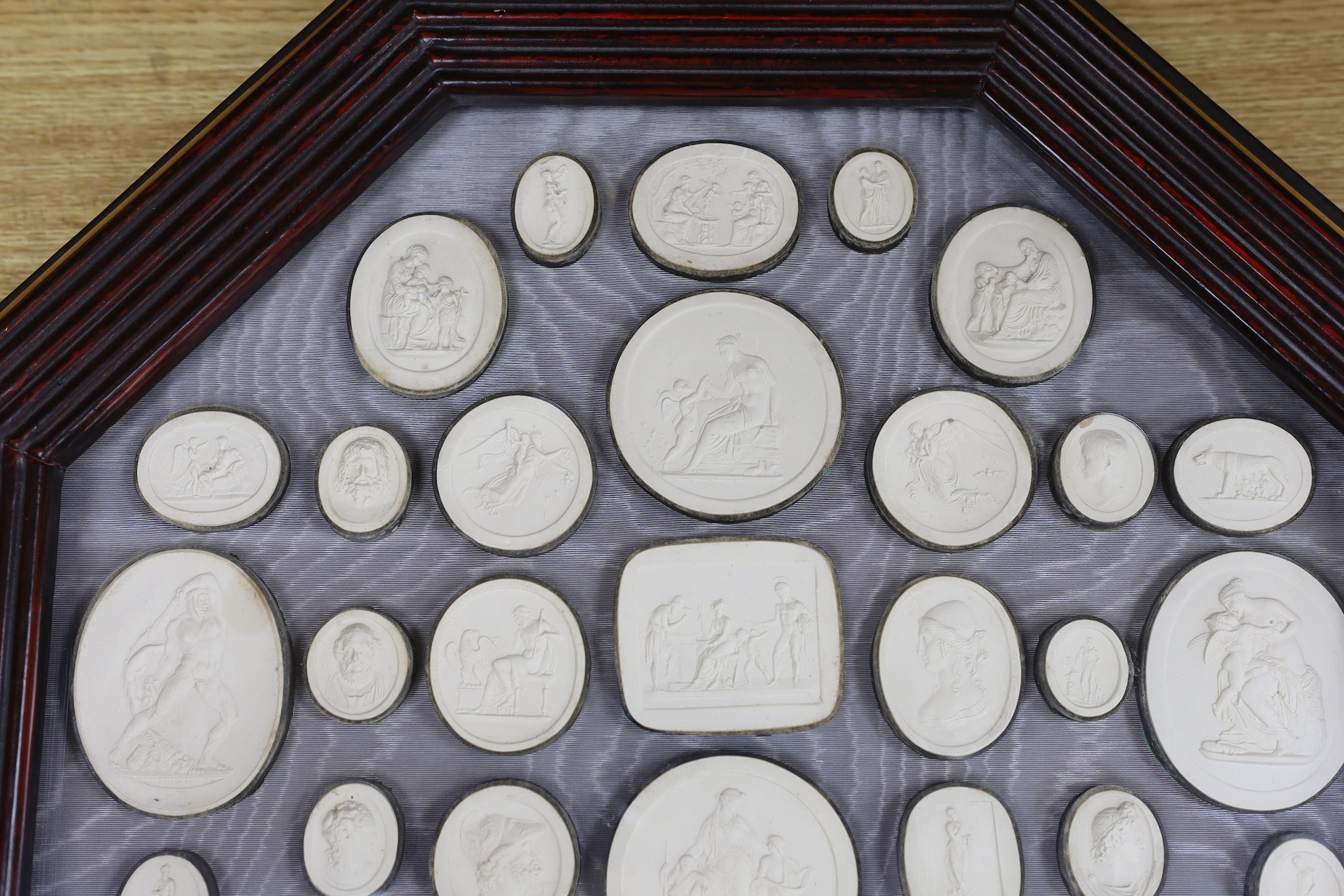 After the antique, a pair of octagonal framed grand tour plaster plaques, 44 x 44cm total